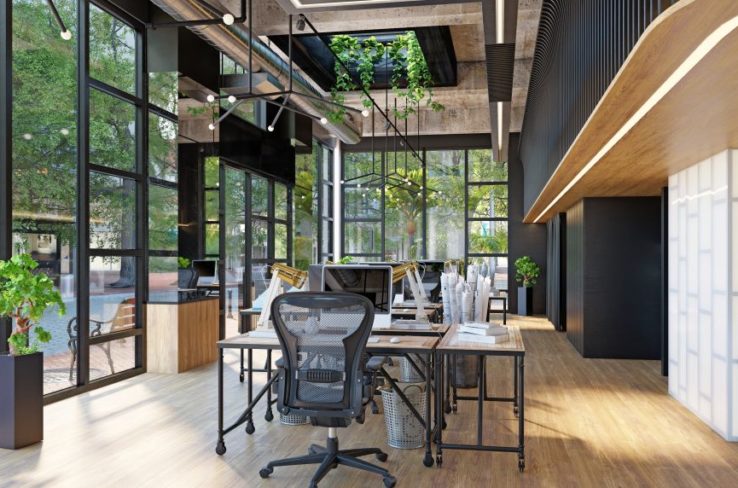 Modern office with glass walls and plants on the side.