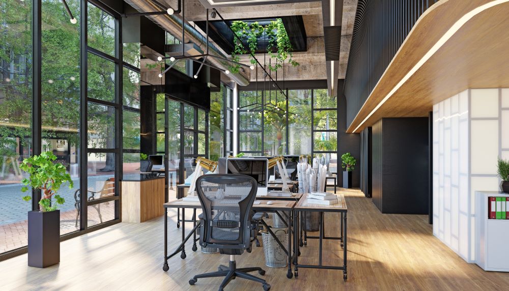 Modern office with glass walls and plants on the side.