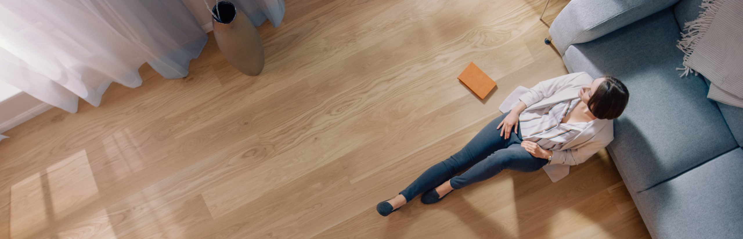 A women sitting on newly laid flooring.