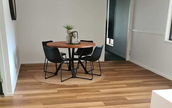 Dining area with blackbutt flooring.