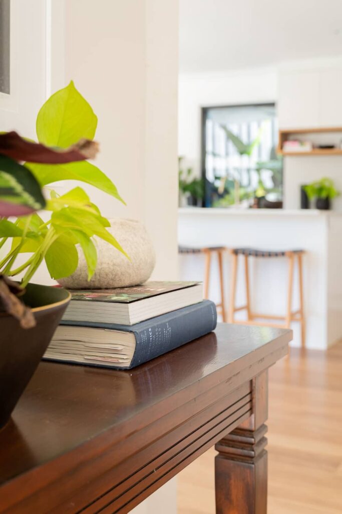 Books and plant on hallway console.