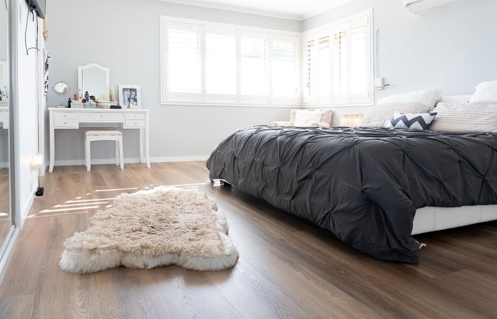 Bedroom with beautiful wooden flooring.