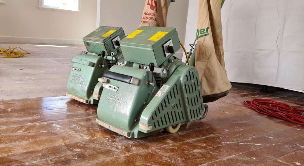 Start with a coarse-grit sandpaper on the drum or belt sander.