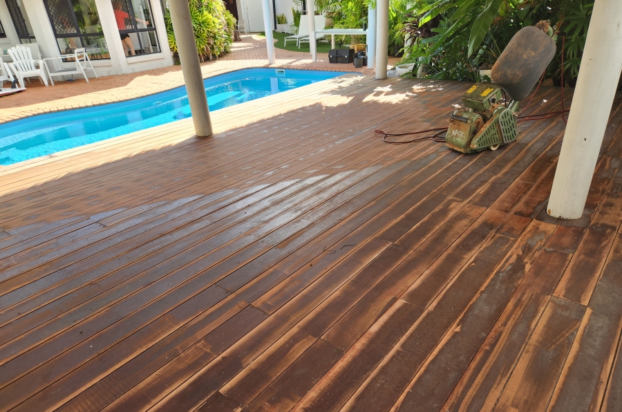 Using a belt or drum sander to smooth out the surface of the deck.