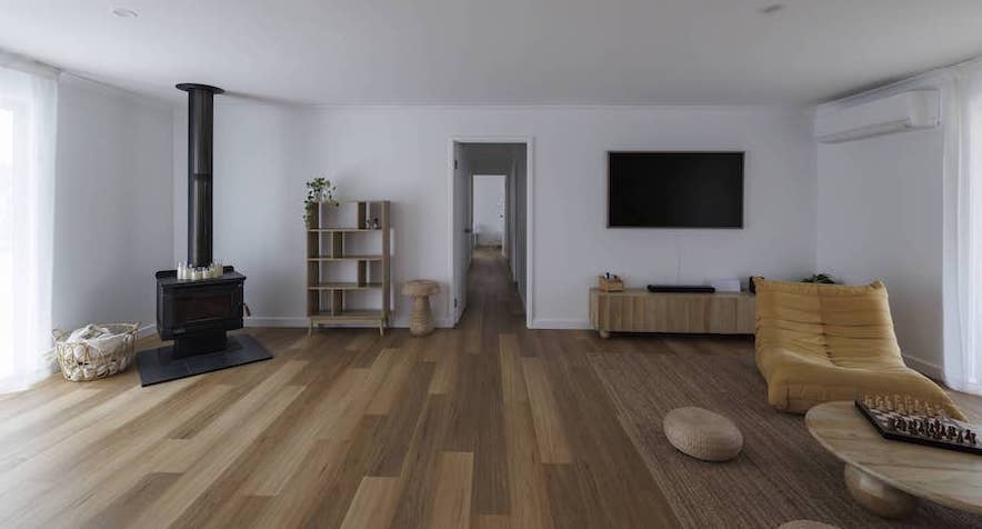 Cosy lounge and fireplace area styled with Eclipse Hybrid with Nazca flooring at Guilderton accommodation