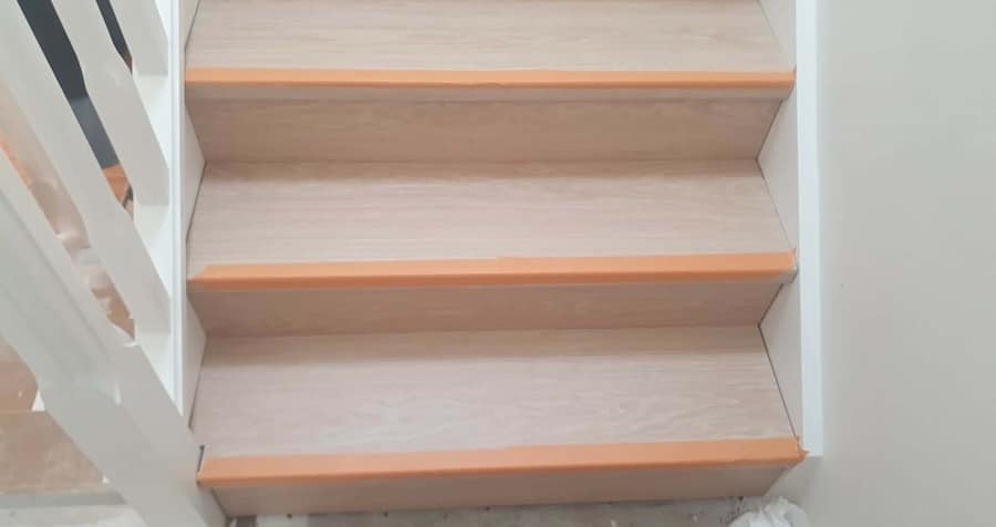 Laminate flooring installed on staircase with stair nosing